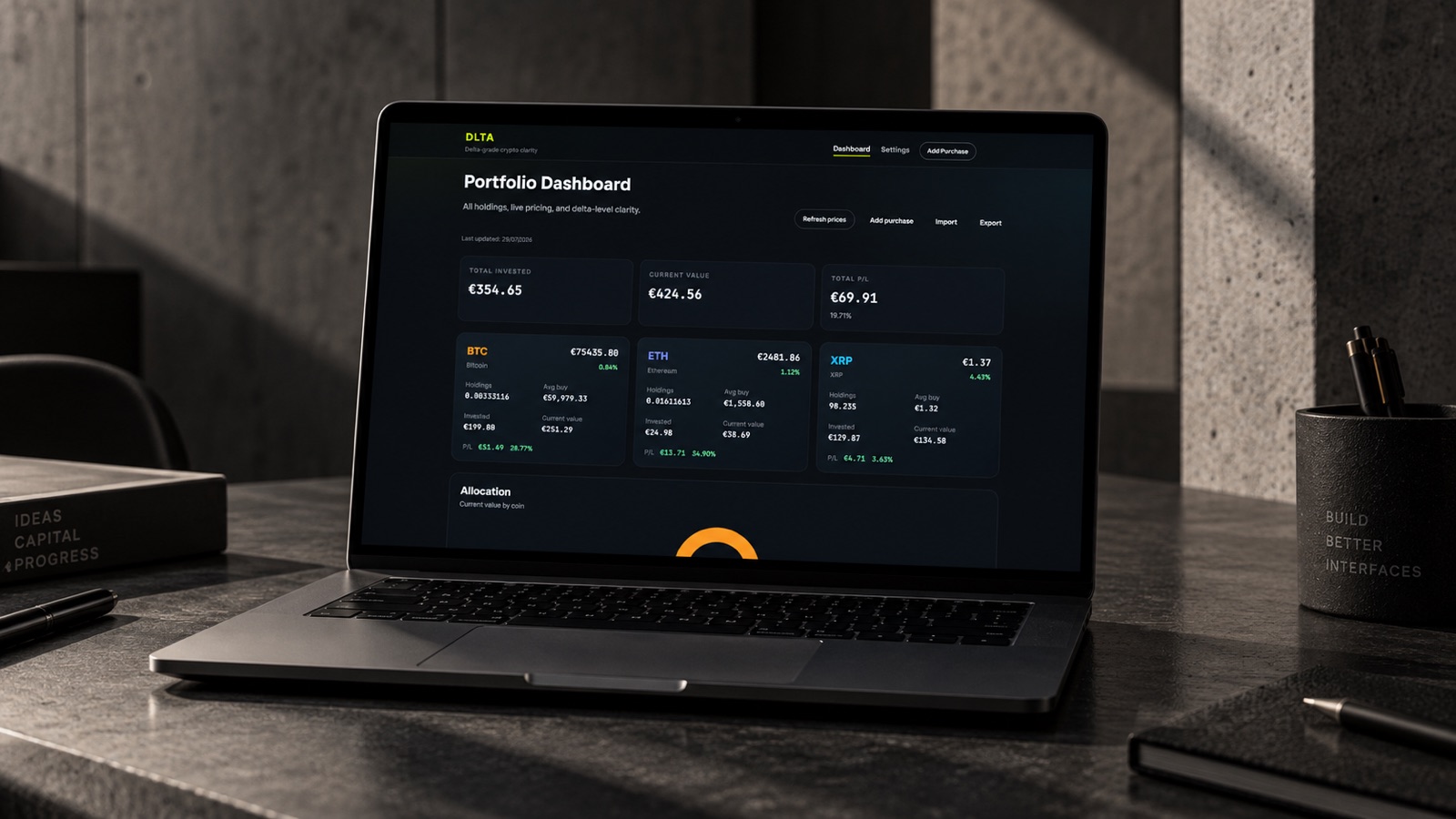 DLTA crypto portfolio dashboard shown on a laptop on a dark desk